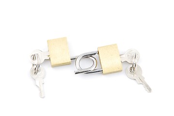 Image showing Two golden padlocks and keys on white