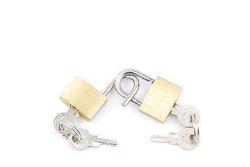 Image showing Two golden padlocks and keys on white