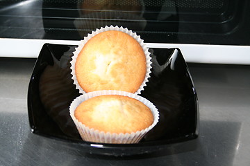 Image showing Two muffins on black plate