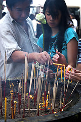 Image showing People light incense at a temple in Bangkok, Thailand