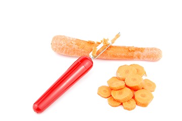 Image showing Peeling a carrot with peeler on white