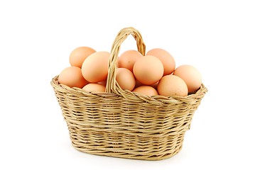 Image showing Eggs in a wicker basket on white