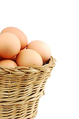 Image showing Close-up of eggs in a wicker basket on white