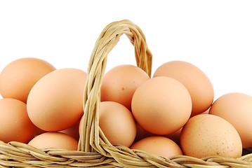 Image showing Close-up of eggs in a wicker basket on white