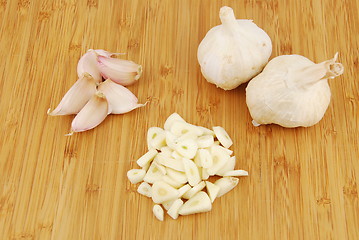 Image showing Garlic preparation ways on a cutting board