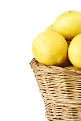 Image showing Close-up of lemons in a wicker basket on white