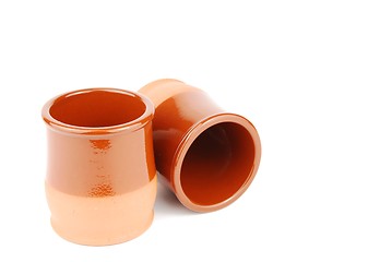 Image showing Vibrant orange ceramic planting pots on white