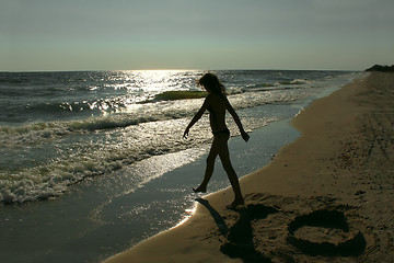 Image showing Silhouette of teenage girl on an empty beach