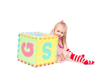 Image showing Little girl playing with cube