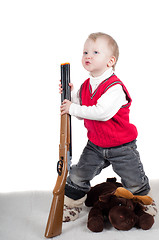 Image showing Little boy playing with gun