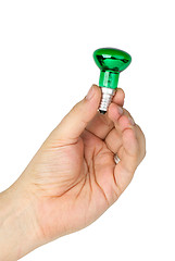 Image showing Hand hold tiny green spot tungsten lightbulb