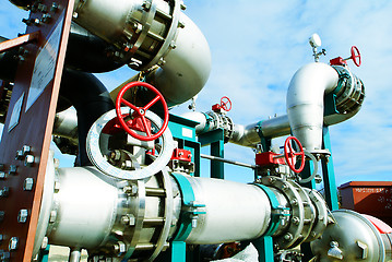 Image showing Industrial zone, Steel pipelines and valves against blue sky