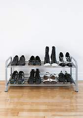 Image showing Shoe rack on a wooden floor