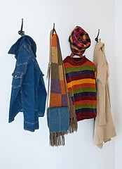 Image showing Colorful clothing on coat hooks