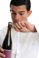 Image showing Closeup man opening wine