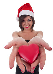 Image showing woman wearing santa hat holds a heart