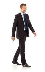 Image showing young businessman is walking