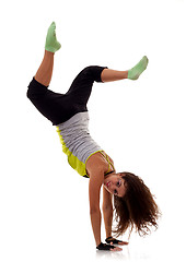 Image showing sporty woman standing on hands