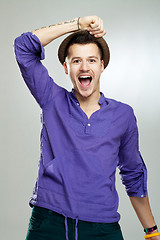 Image showing excited young man wearing a hat