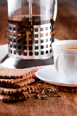 Image showing french press, cup of herbal tea and some fresh cookies