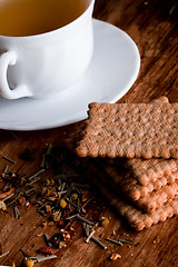 Image showing cup of fresh herbal tea and some cookies 