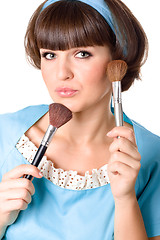 Image showing brunet woman with two make-up brushes