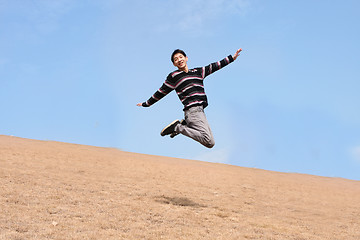 Image showing Happy jumping man on winter day 