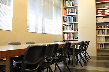 Image showing library stacks of books with table 