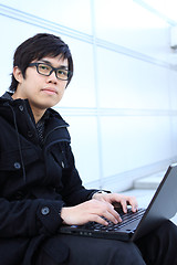 Image showing young man works for a laptop 