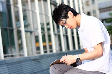 Image showing chinese man studing outdoor