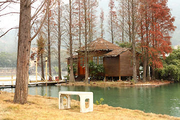 Image showing white chiar and house on water front property 