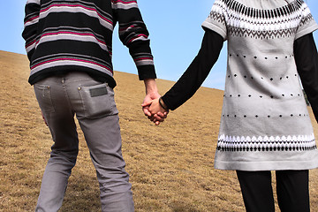 Image showing Hand-in-hand. Couple love in autumn scenery 