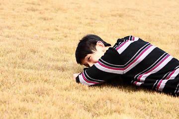 Image showing Young man lying on grass 