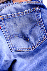 Image showing Fragment of blue modern jeans with pocket, can be used as a back