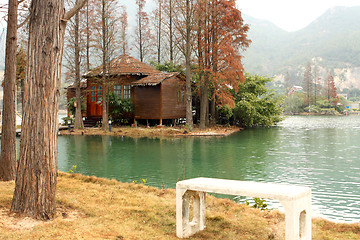 Image showing white chiar and house on water front property 