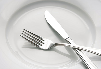 Image showing Fork and knife on a white plate
