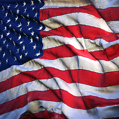 Image showing Flag of the United States, fluttering in the breeze, backlit ris