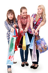 Image showing Three girls with colorful shopping bags