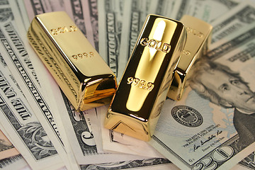 Image showing three gold bars on dollar bills