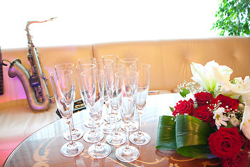 Image showing Flowers, glasses and saxophone