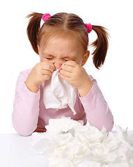 Image showing Little girl blows her nose