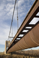 Image showing Old rusty aqueduct across a river