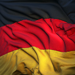 Image showing Flag of Germany, fluttering in the breeze, backlit rising sun