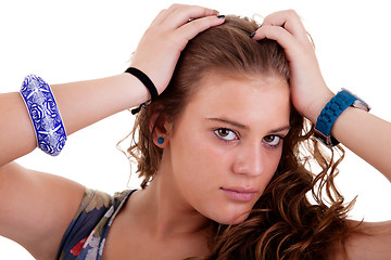 Image showing beautiful young woman, holding her hair with his hands