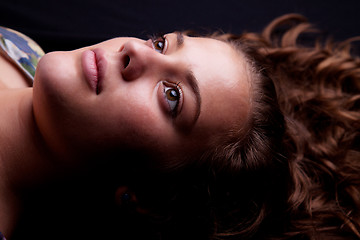 Image showing beautiful girl lying looking up