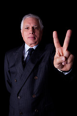 Image showing businessman with thumb raised as a sign victory