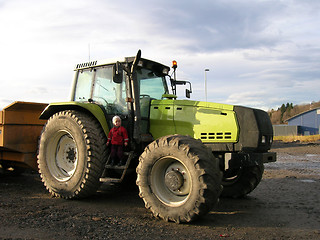 Image showing Small kid, big tractor