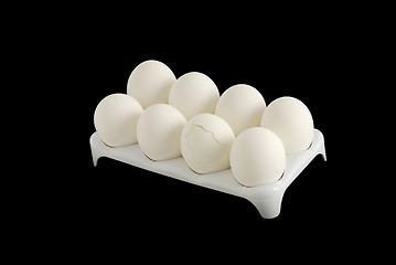 Image showing Eight white eggs with one cracked in carton