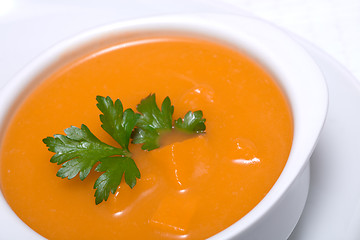 Image showing Pumpkin soup in white bowl  with parsley