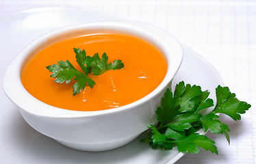 Image showing Pumpkin soup in white bowl  with parsley